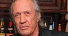 Carradine's body to return home, while questions remain