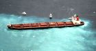 Crews begin moving oil from ship stuck on reef