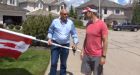 Man places Canadian flags on the lawns of generous citizens
